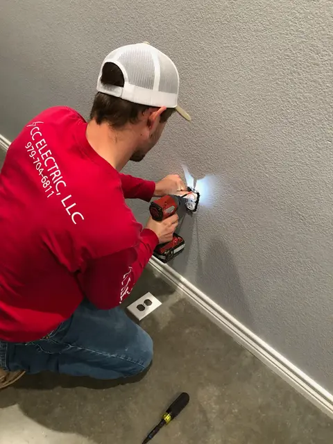 CC Electric electrician installing an outlet in a local home